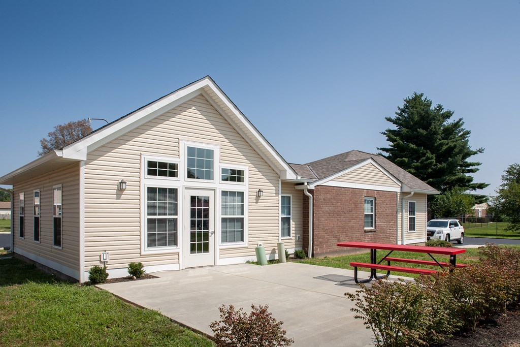 a small building with a patio and a picnic table