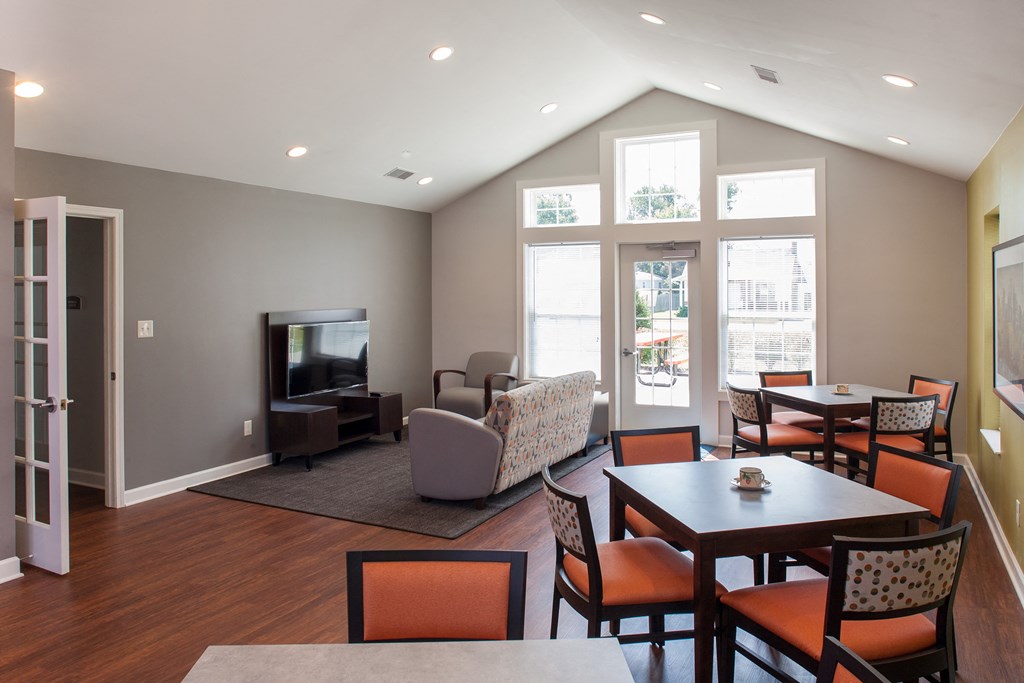 a living room with a table and chairs and a television