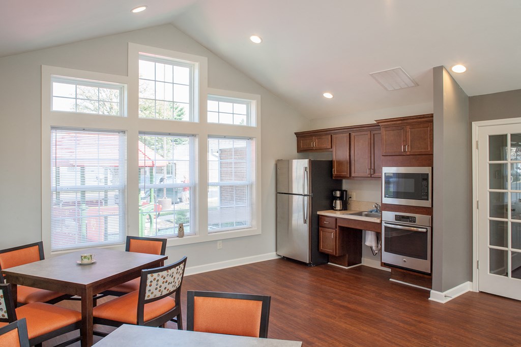 a kitchen and dining room with a table and chairs