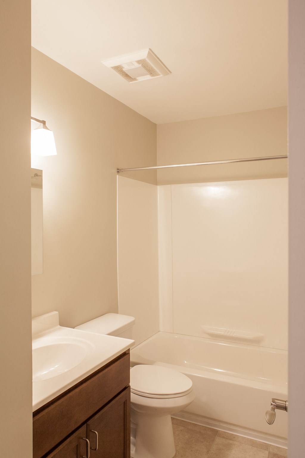 a bathroom with a toilet and a sink and a shower