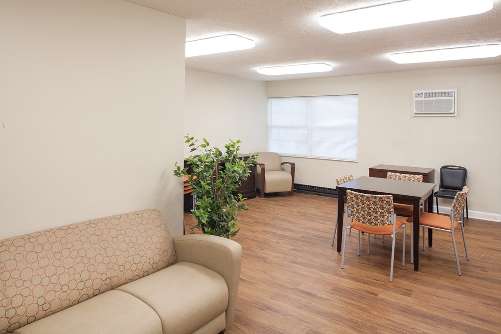 a living room and dining room with a table and chairs