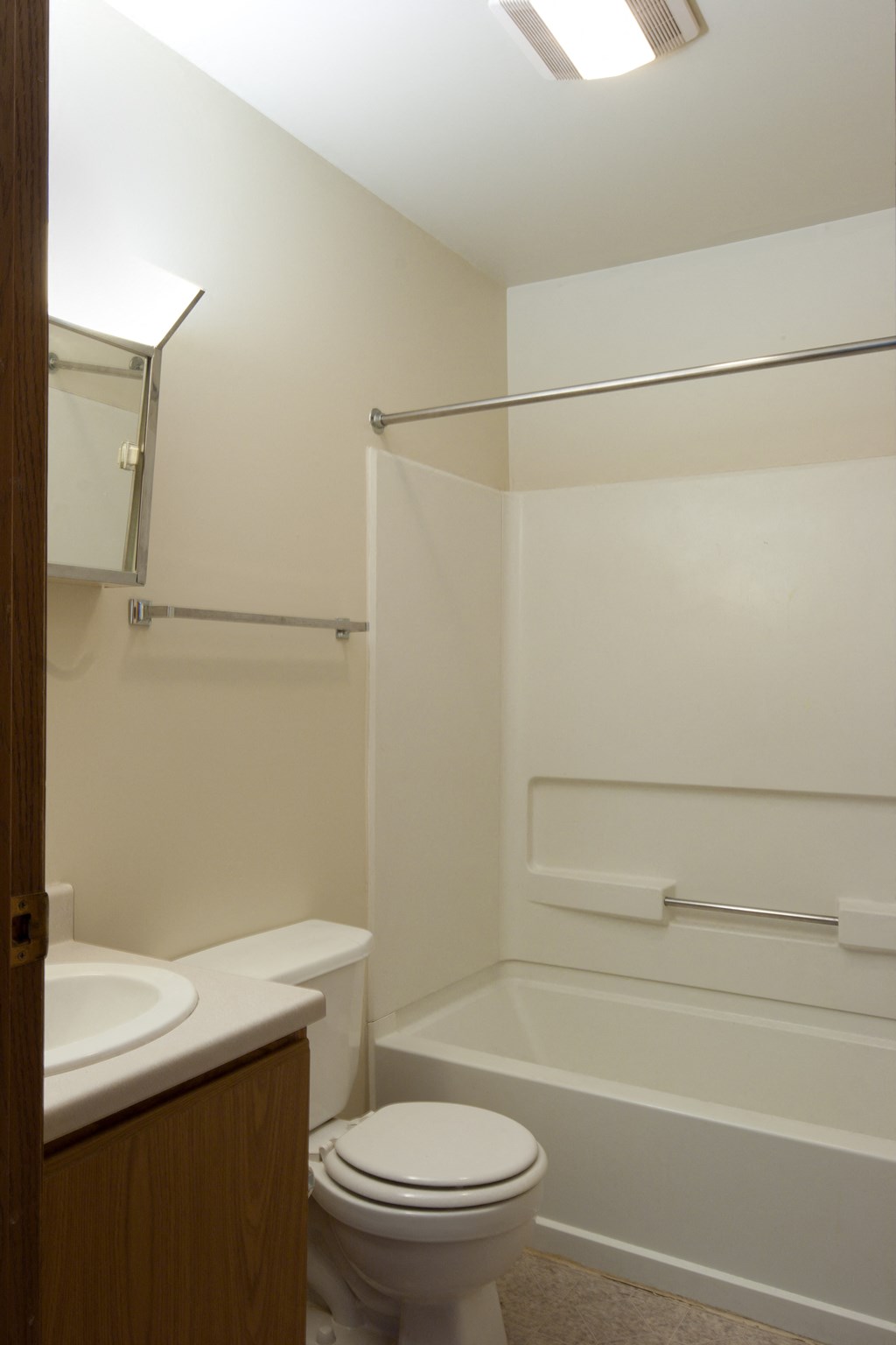 a bathroom with a toilet and a sink and a shower