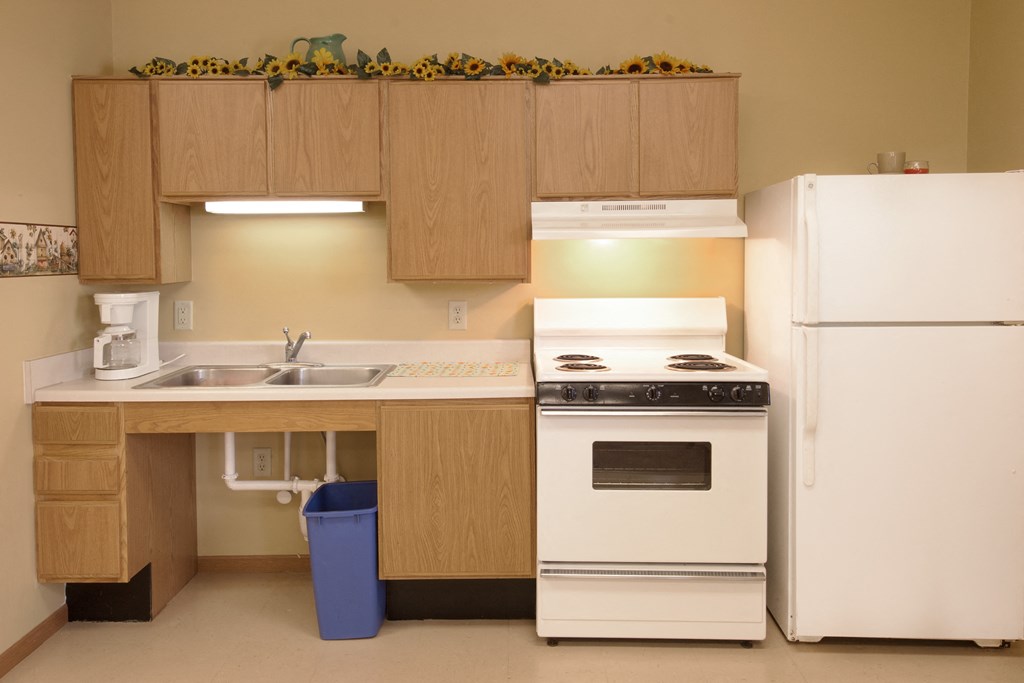 a kitchen with white appliances and a sink and a refrigerator