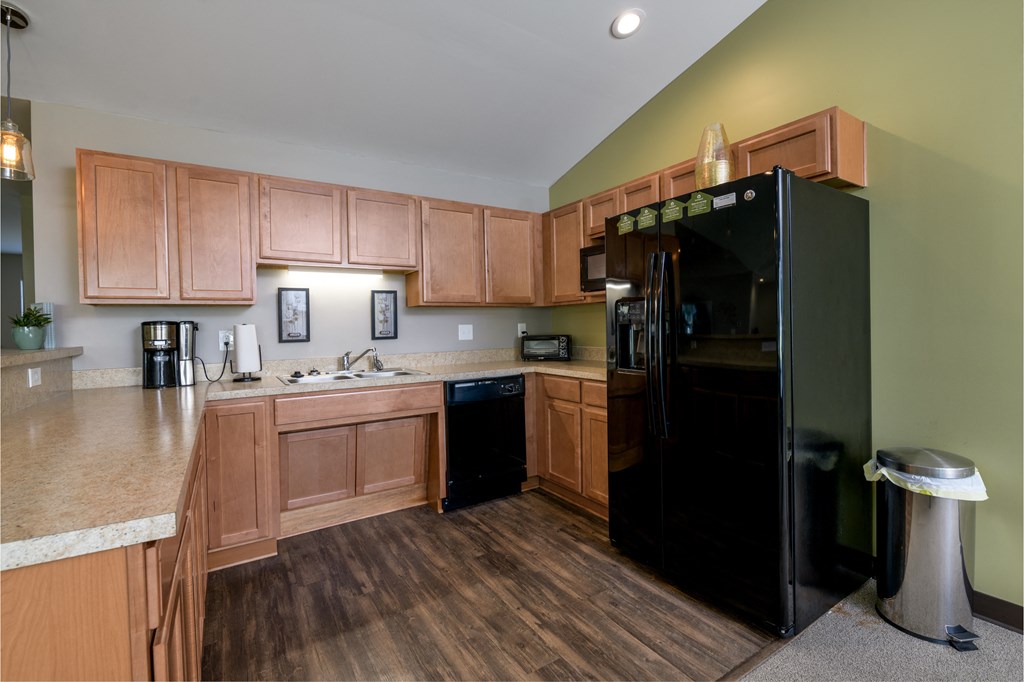 a kitchen with black appliances and wooden cabinets