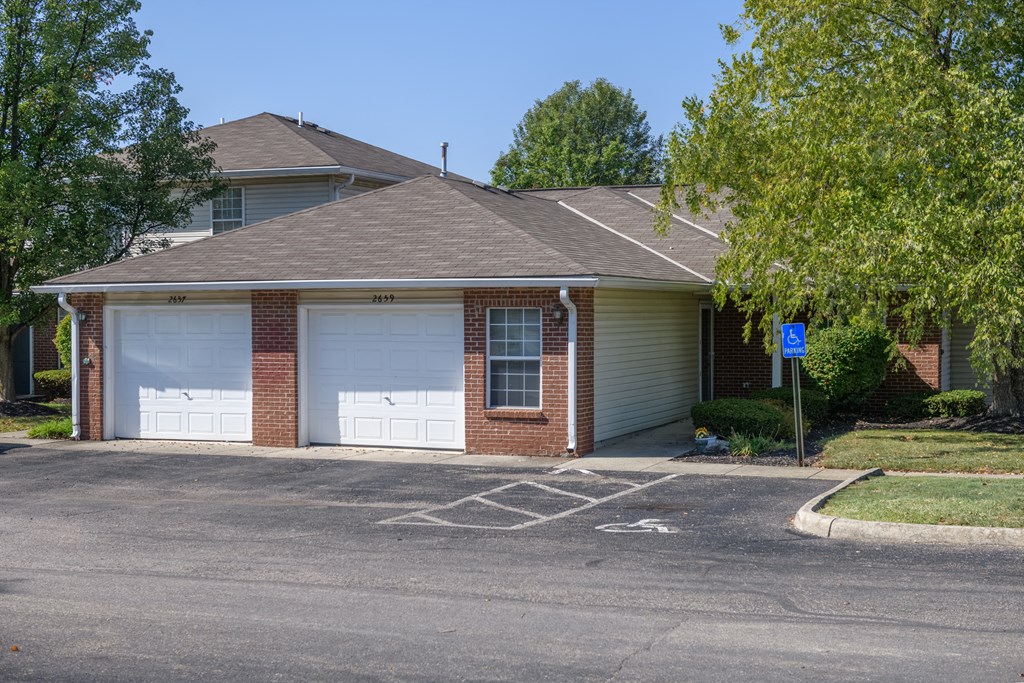 a house with two garage doors and a parking lot