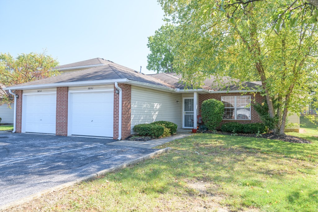 the front of a house with a white garage door