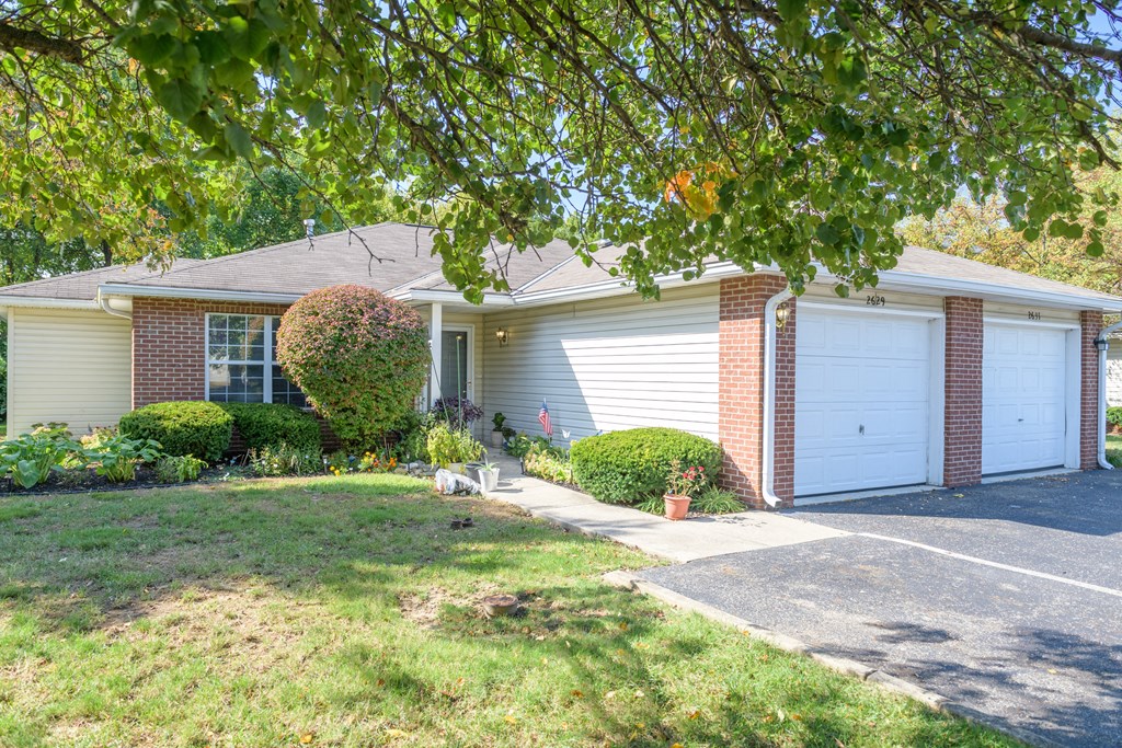 a white house with a white garage door and a driveway