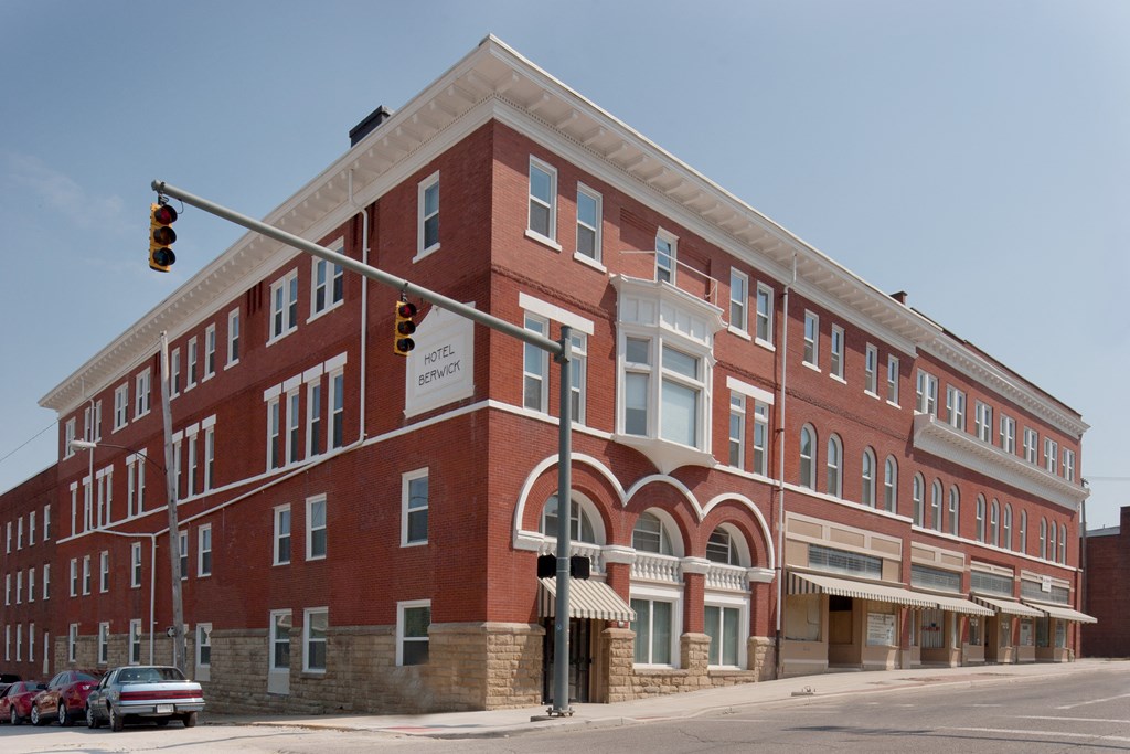 a red brick building on the corner of a street