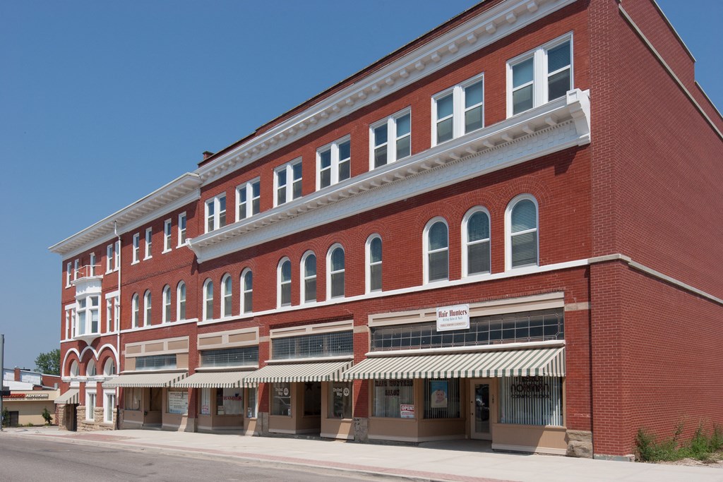 a red brick building with an awning on a street