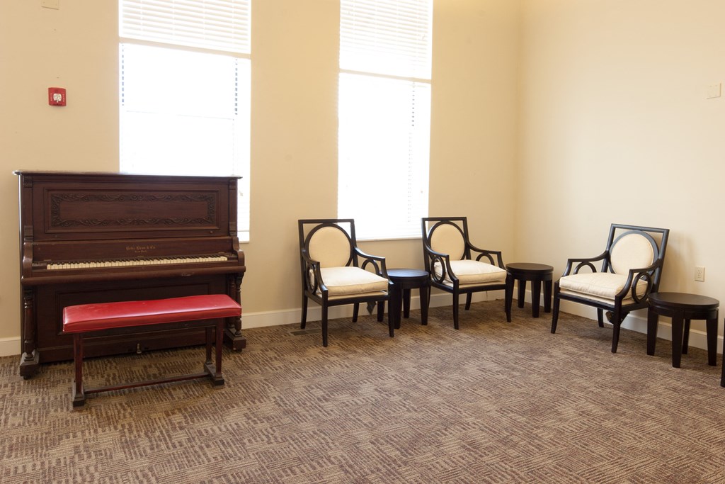 a group of chairs and a piano in a room