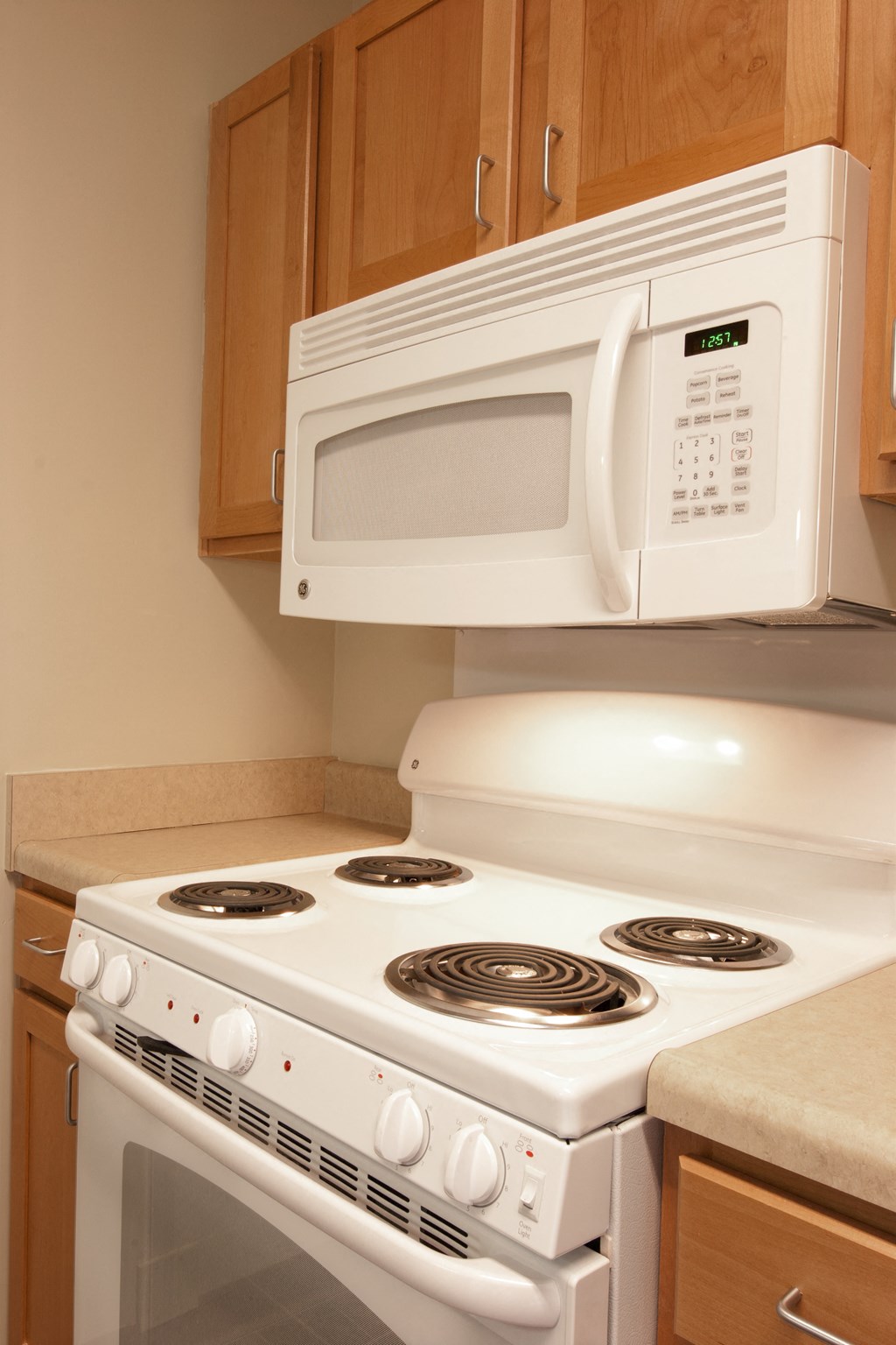 a white stove and microwave in a kitchen
