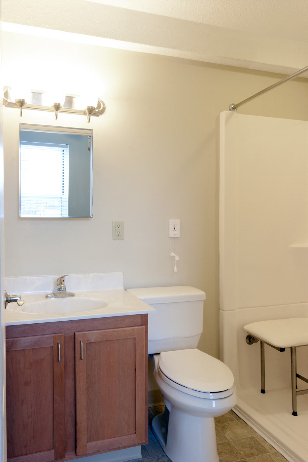 a bathroom with a toilet and a sink and a shower