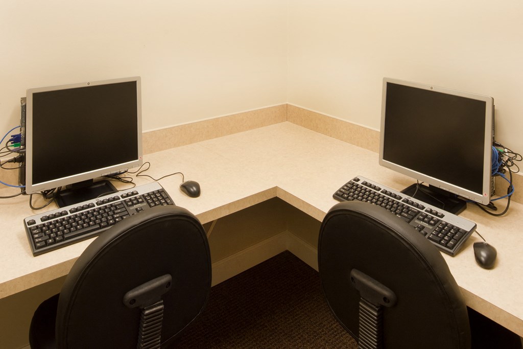 a desk with two computers and two keyboards on it