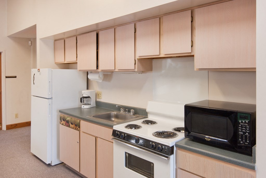 a kitchen with a stove microwave and refrigerator