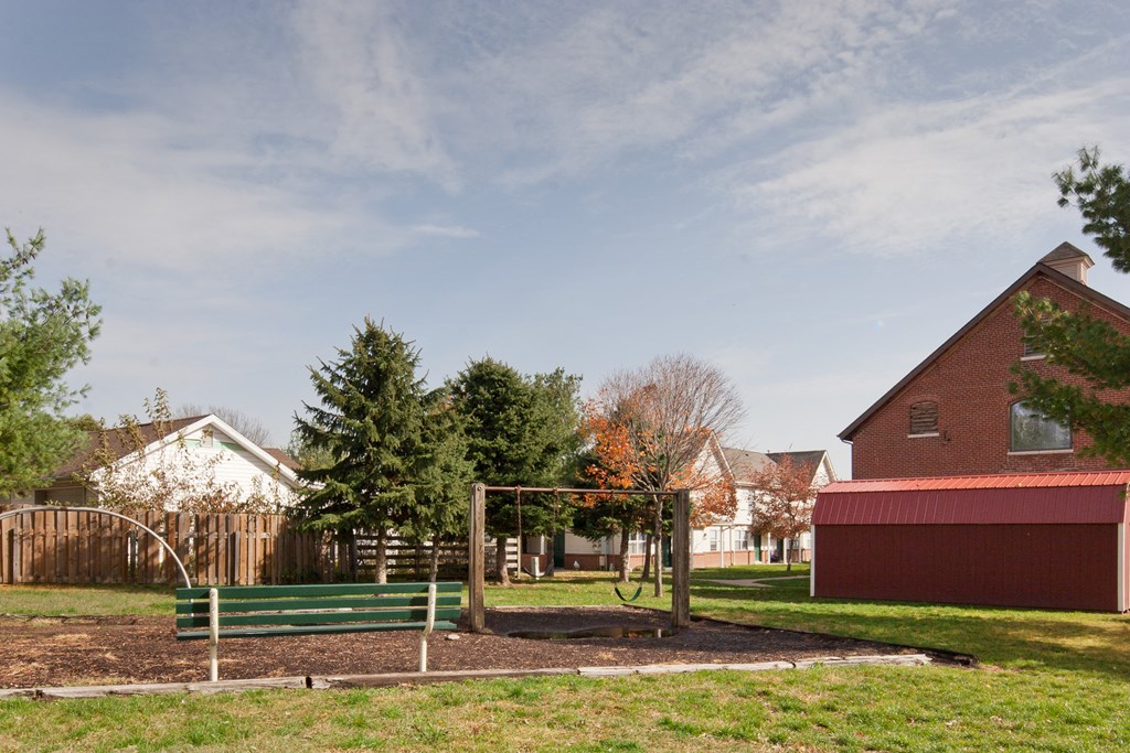 a park with a swing set and a playground