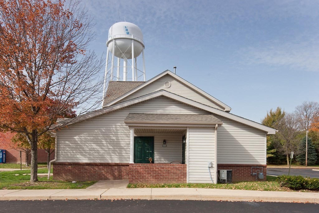 a white church with a water tower behind it