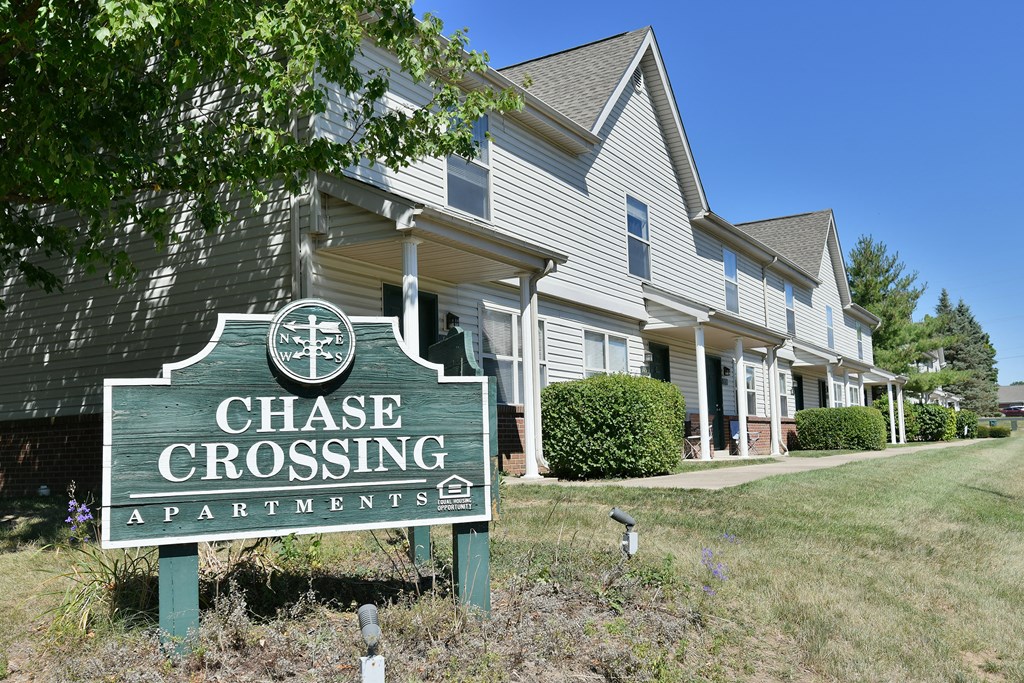 a chase crossing apartments sign in front of a house