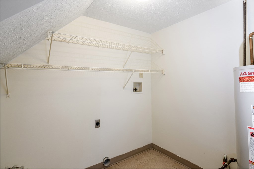 a room with a white wall and a white shelf on the wall