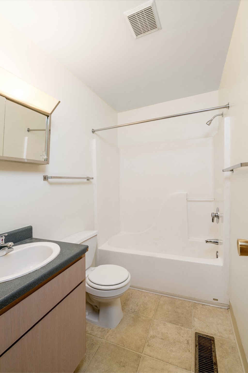 a bathroom with a toilet and a sink and a shower