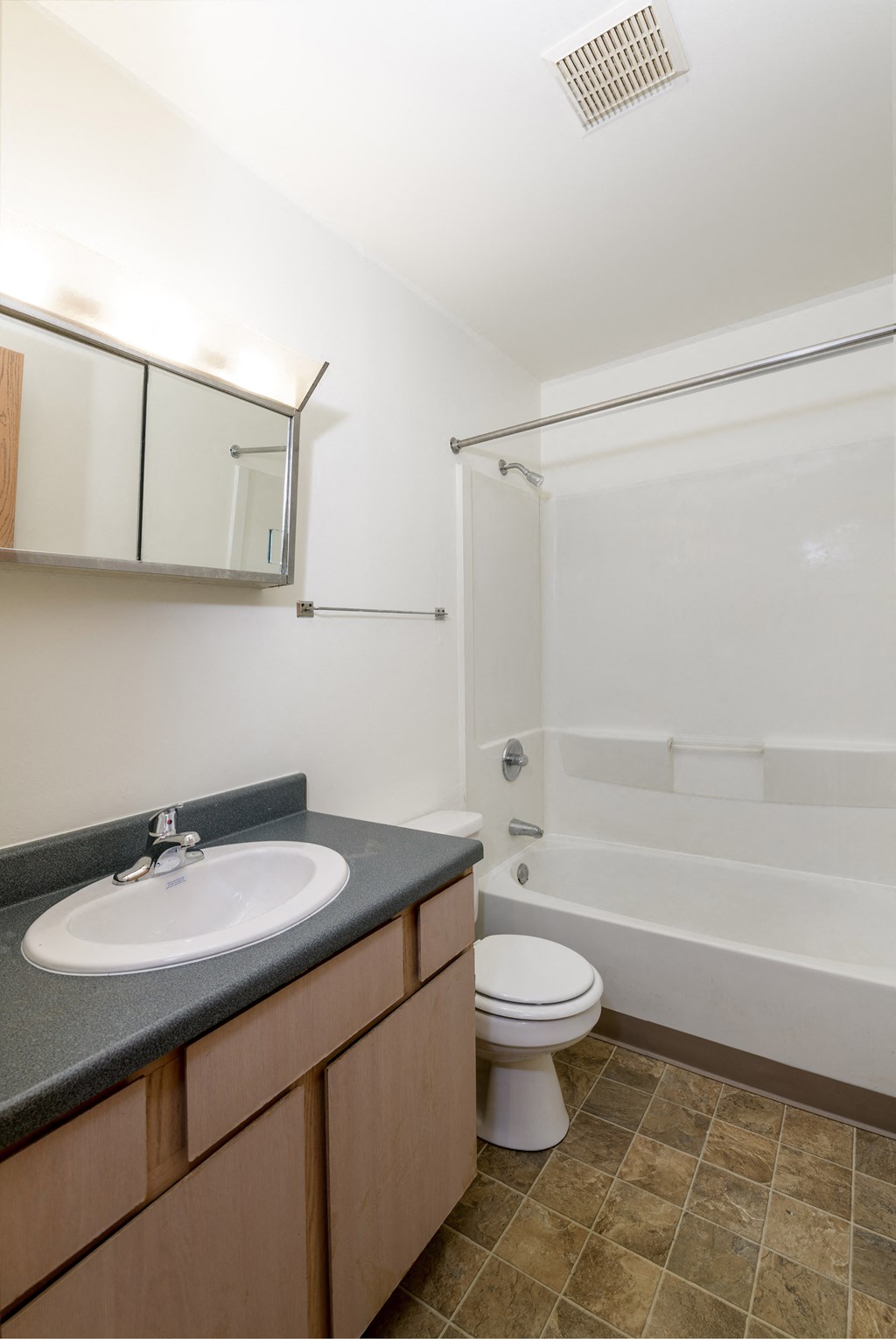 an empty bathroom with a sink toilet and shower