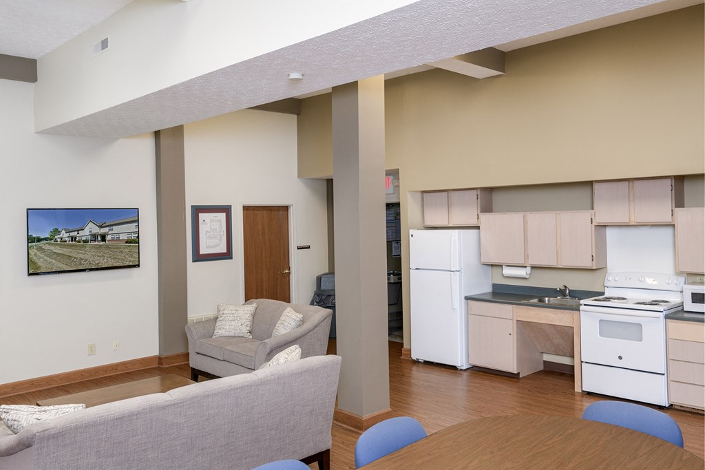 a kitchen and living room with a table and chairs