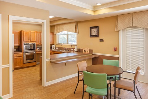 a kitchen and dining room with a table and chairs