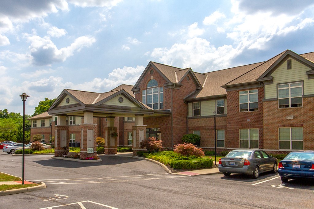 a large brick building with cars parked in front of it