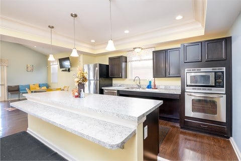 a kitchen with a marble counter top and black appliances