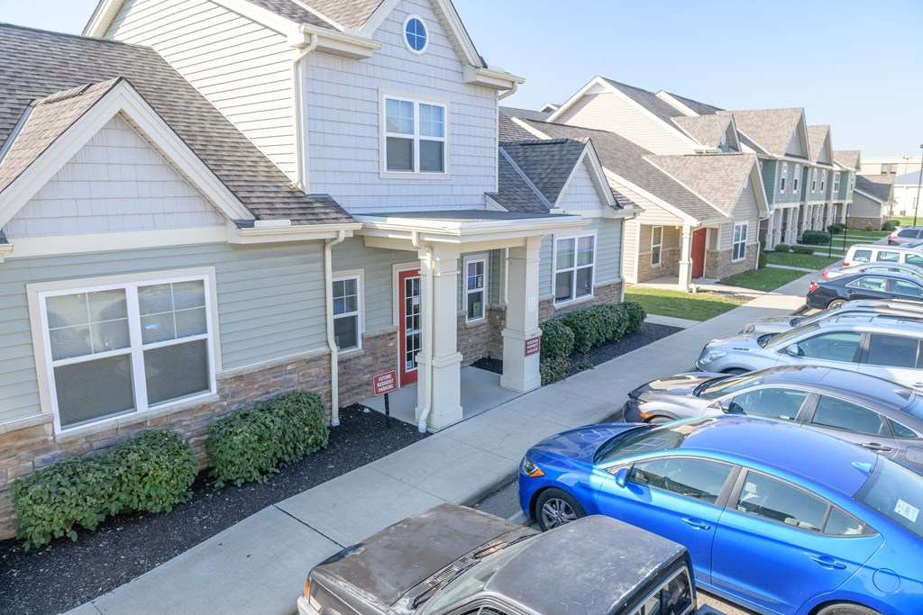 a row of cars parked in front of houses
