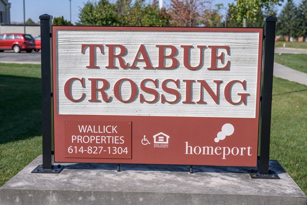 a sign that reads tribute crossing in front of a sidewalk
