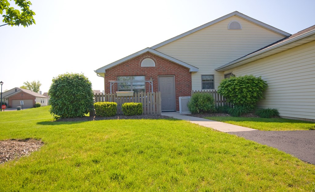 a house with a yard and a sidewalk in front of it