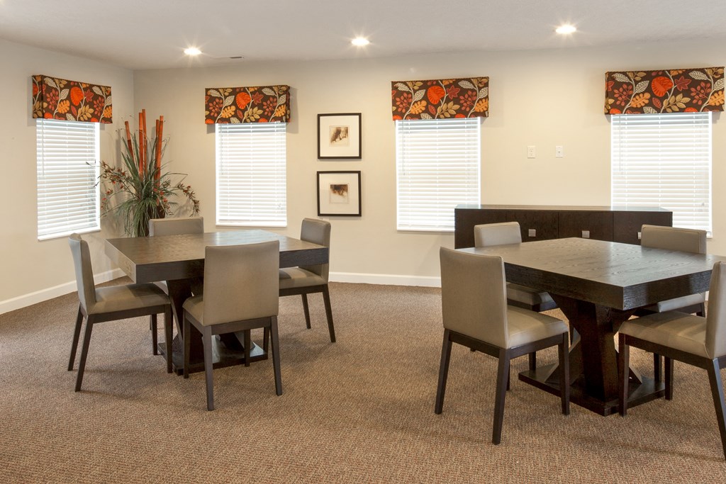 a dining room with a table and chairs
