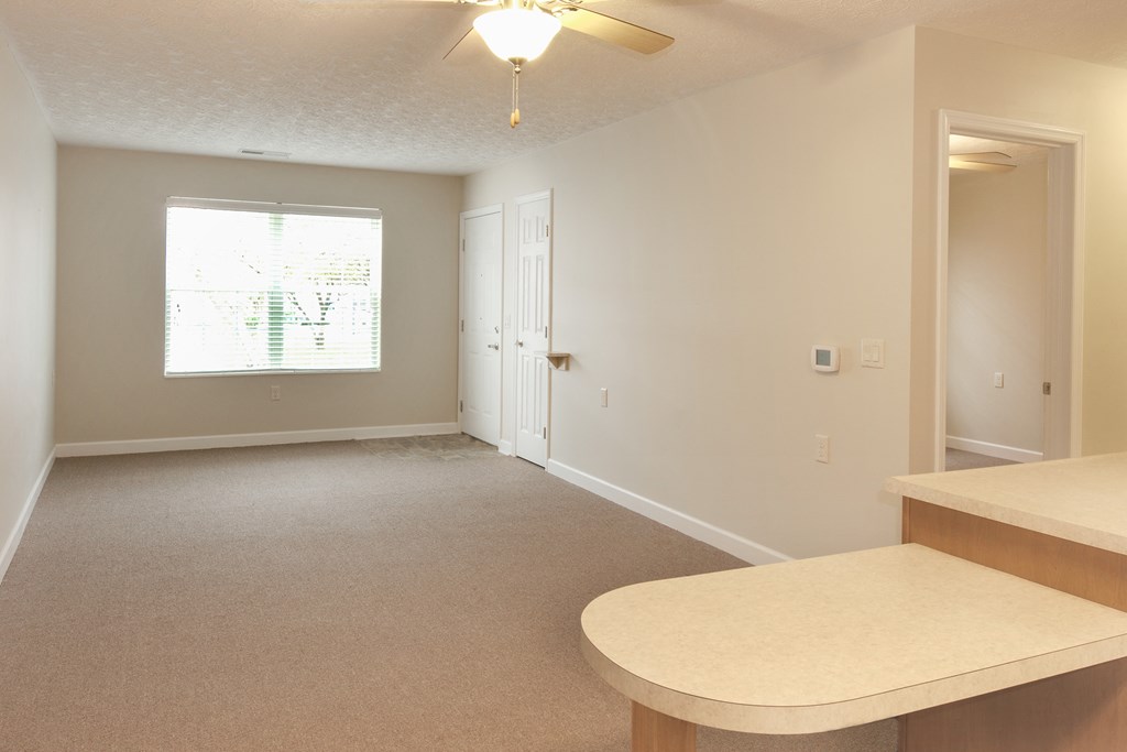 an empty kitchen and living room in an empty house