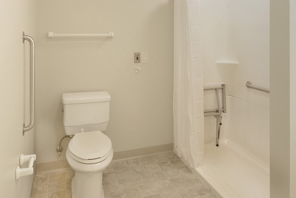 a bathroom with a toilet and a shower