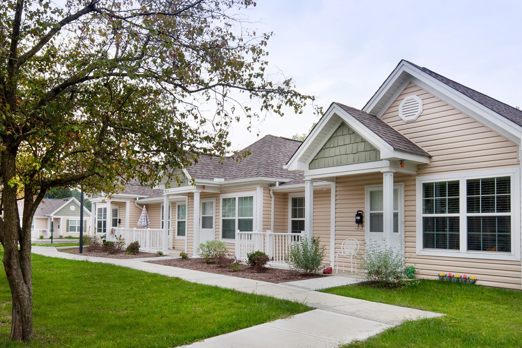 a row of houses with a sidewalk in front of them