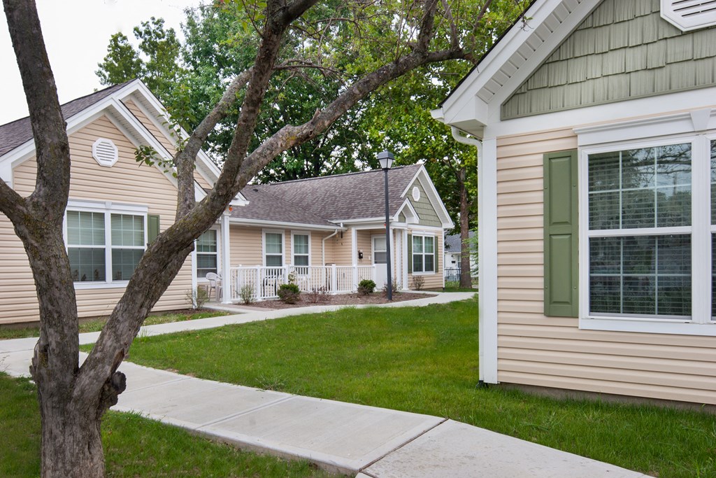 a sidewalk in front of a row of houses