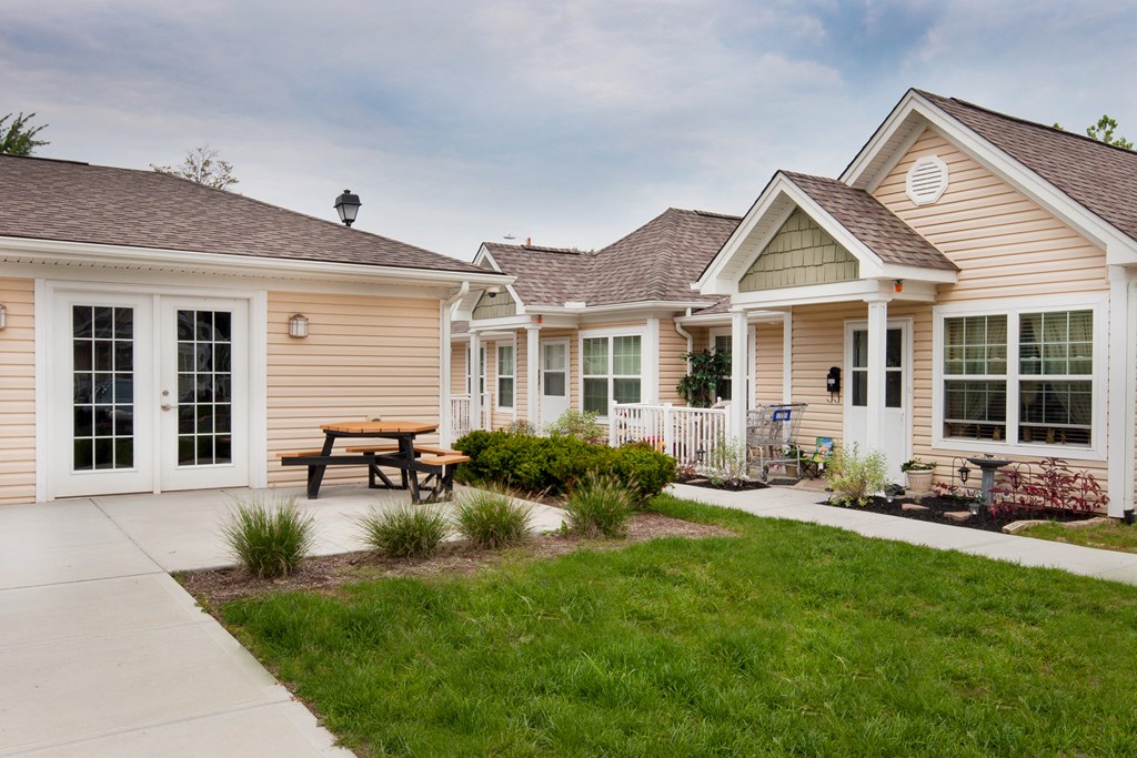 a group of homes with a picnic table in the yard