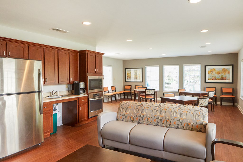 a living room with a couch and a kitchen and dining room
