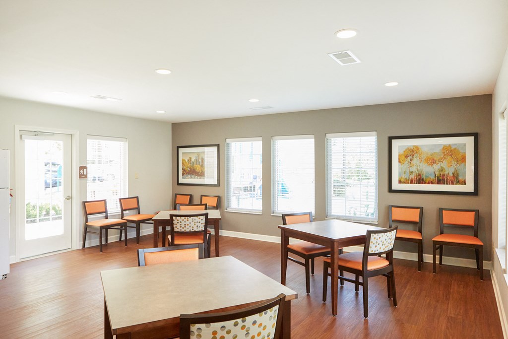 a dining room with tables and chairs and windows