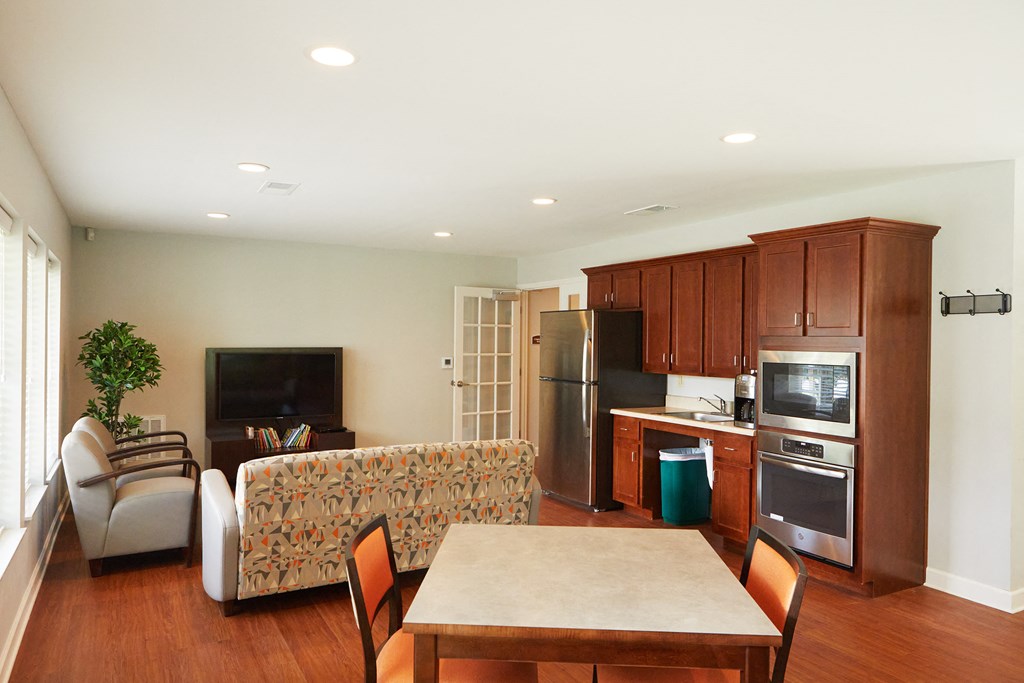 a kitchen and living room with a table and chairs