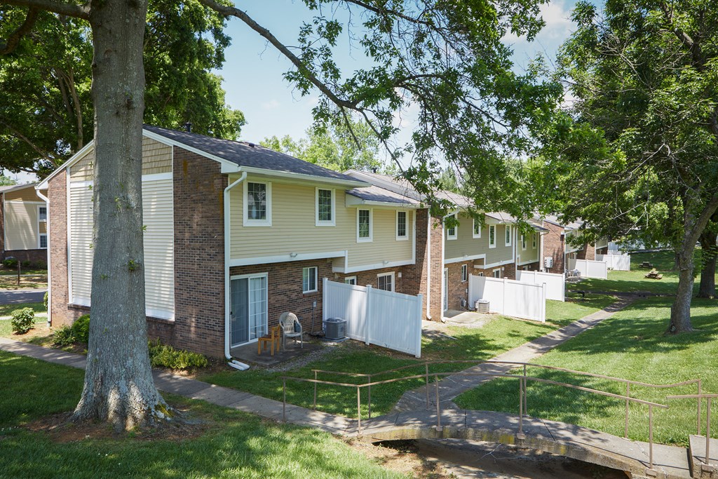 a row of houses in a neighborhood with trees