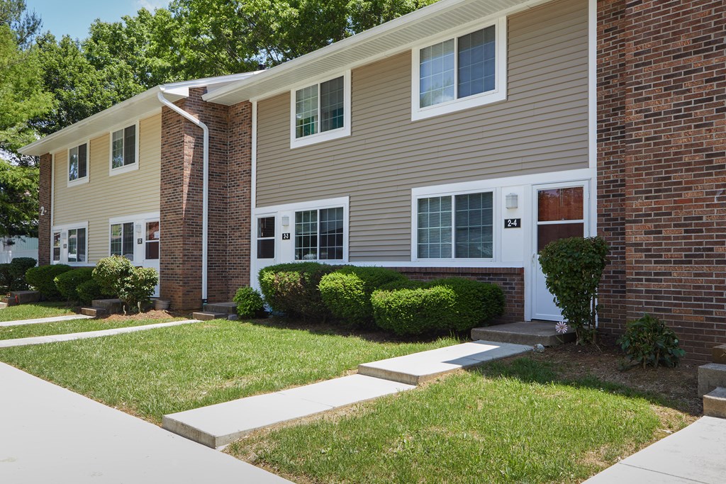 a house with a sidewalk in front of it