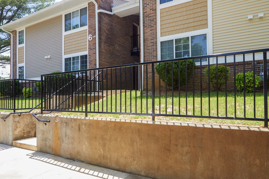 a view of a house with a fence in front of it