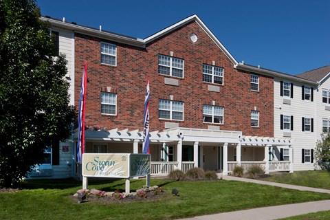 the front of a brick building with a sign in front of it