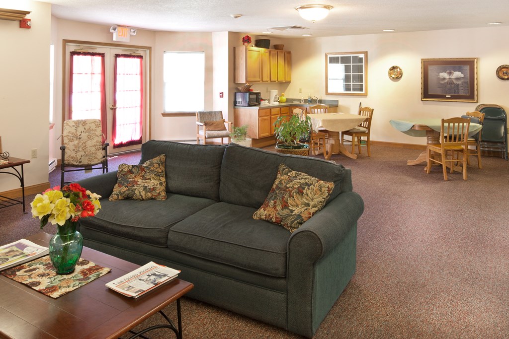 a living room and dining room with a couch and a table