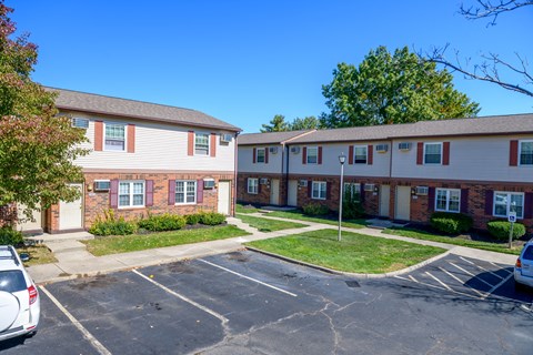 an empty parking lot in front of an apartment building