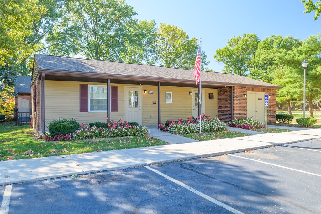 a small yellow house with an flag in front of it