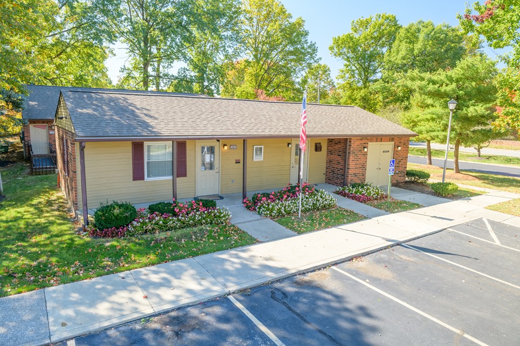 a small yellow house with an flag in front of it
