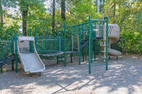a playground with a slide and a swing set