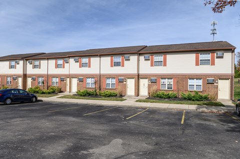 a parking lot in front of an apartment building